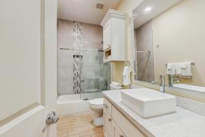 a bathroom with a sink and a toilet and a shower at Harbor Island Retreat in Port Isabel +17 photos