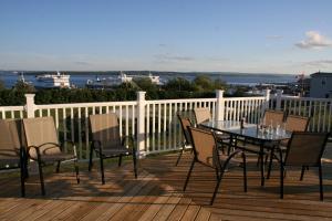 a patio with a table and chairs on a deck at Hotel North in North Sydney