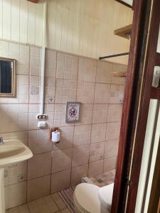a bathroom with a toilet and a sink at Spacious apartment with air conditioning in Puerto Viejo