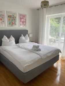 a bedroom with a bed with two towels on it at Rose Garden Retreat Private Terrace Baden-Baden in Baden-Baden