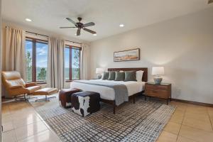 a bedroom with a large bed with a ceiling fan at Luxe Villa Expansive Yard Near Rapid City in Rockerville