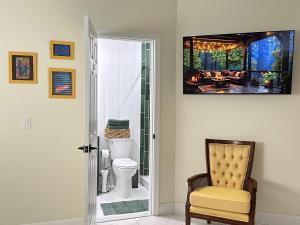 a living room with a television on the wall at Magic Secluded Suite-Pool-Sauna plus Lake View Venice Florida in Venice