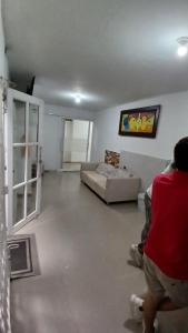 a person standing in a living room with a couch at Hotel Central La Jagua in La Jagua de Ibirico