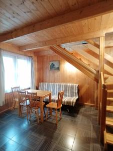 a room with a table and chairs and a couch at Domek dla rodziny in Jastarnia