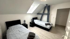 a bedroom with two beds and a window at Loft9 Architektenwohnung mit Dachterrasse Zentral in Lübeck