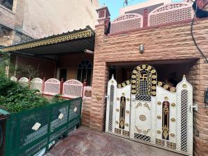 a gate to a house with a fence at House of Tourists in Jodhpur