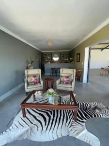 a living room with a zebra printed table and chairs at Achab Camping Camp site in Usakos