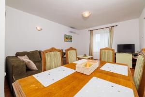 a living room with a table and a couch at Apartments Mirela in Karlobag