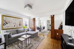 a living room with a couch and a tv at Villa Italia in Miami Beach