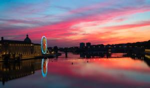 a sunset over a city with a river and a building at LA DUNE - Gare Matabiau - PARKING & WIFI in Toulouse