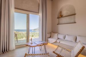 a living room with a couch and a large window at Villa Nanoula & Villa Stella Twin Villas Retreat in Skopelos Town