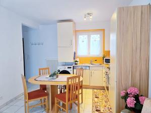 a kitchen with a table and chairs in a kitchen at Casa Orange in Cadenazzo