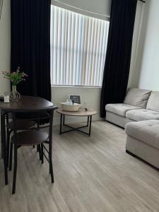 a living room with a table and a couch at Casa Blanca Private Suite in Lehigh Acres