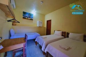 a hotel room with two beds and a sign on the wall at Pousada EcoVillage - Meu Xodó em Preá in Prea +82 photos