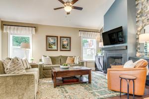 a living room with couches and a fireplace at Walk to Dtwn Waynesville Home with Deck! in Waynesville