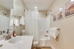 a white bathroom with a sink and a shower at Walk to Dtwn Waynesville Home with Deck! in Waynesville +16 photos