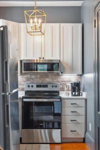 a kitchen with a stove and a refrigerator at Beautiful Renovated Apartment One Block from King in Charleston