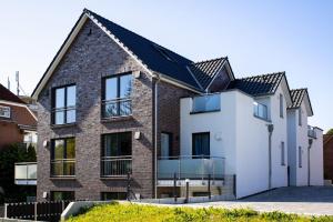 a brick house with a black roof at Flussblick am Töpferberg 5 in Bad Schwartau