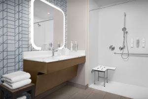 a bathroom with a sink and a mirror and a shower at Homewood Suites By Hilton Columbia Downtown in Columbia +21 photos