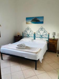 a bedroom with a bed with a blue headboard at Villette Oasi in San Teodoro