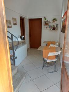 a room with a table and a table and a chair at B&B Coccinelle in San Vito lo Capo