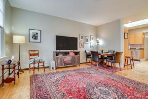 a living room with a television and a table and chairs at Less Than 1 Mi to Xcel Energy Center Walkable Hideaway! in Saint Paul
