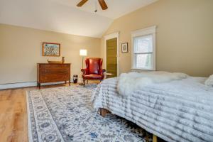 a bedroom with a bed and a chair and a window at Less Than 1 Mi to Xcel Energy Center Walkable Hideaway! in Saint Paul