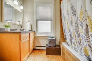 a bathroom with a tub and a shower curtain at Less Than 1 Mi to Xcel Energy Center Walkable Hideaway! in Saint Paul
