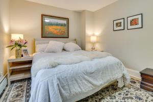a bedroom with a large white bed and a painting at Less Than 1 Mi to Xcel Energy Center Walkable Hideaway! in Saint Paul