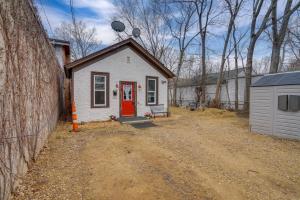 a small house with a red door on a dirt road at Less Than 1 Mi to Xcel Energy Center Walkable Hideaway! in Saint Paul