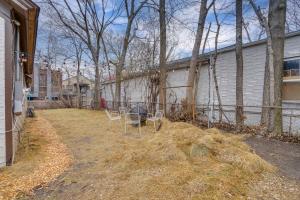 a yard with chairs and a table in it at Less Than 1 Mi to Xcel Energy Center Walkable Hideaway! in Saint Paul