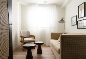 a living room with a couch and a chair at The Milo in Santa Barbara