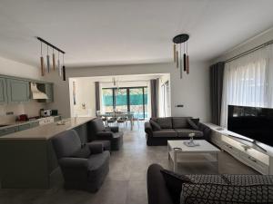 a living room with couches and a kitchen and a living room at Villa Adventure in Bodrum City