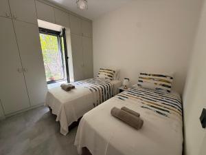 two beds in a white room with a window at Villa Adventure in Bodrum City +19 photos