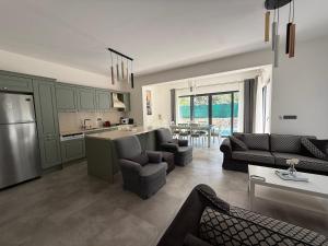 a kitchen and living room with green cabinets and a living room at Villa Adventure in Bodrum City