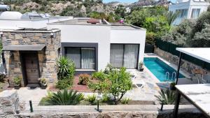 a villa with a swimming pool and a house at Villa Adventure in Bodrum City