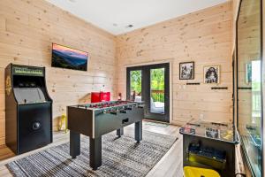 a room with a pool table and a arcade game at Velvet Monkey Retreat in Sevierville