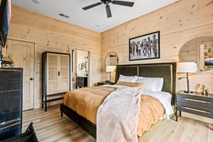 a bedroom with a bed and a ceiling fan at Velvet Monkey Retreat in Sevierville +47 photos