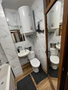 a bathroom with two toilets and a sink at Однокімнатна квартира in Chernivtsi
