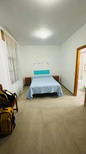 a bedroom with a bed in a white room at Hostal Extrelucía in Calzadilla +13 photos