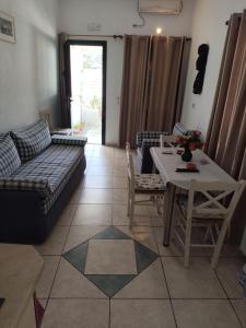 a living room with a couch and a table at Nikolettas Apartments in Faros