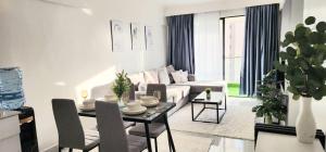 a white living room with a table and a couch at American Hospice in Nairobi