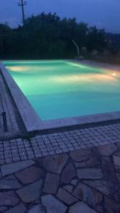 a pool of blue water at night at LA CASA FRA gli ULIVI UMBRA in Terni