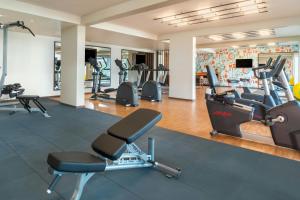 a gym with treadmills and elliptical machines at Le Meridien Goa, Calangute in Calangute