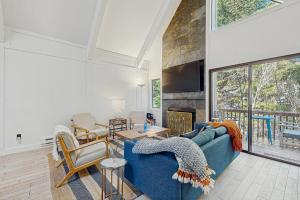a living room with a blue couch and a fireplace at The Wild Pine Lodge in Incline Village
