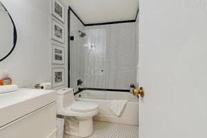 a bathroom with a toilet and a tub and a sink at The Wild Pine Lodge in Incline Village +13 photos