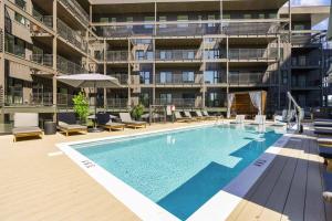 an outdoor swimming pool in front of an apartment building at Life of the Party, Unit #418 in Nashville