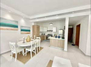 a kitchen and dining room with a table and chairs at Beautiful Two bedrooms apartment in Punta Cana