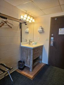 a bathroom with a sink and a mirror at 1st Choice Inn of Rawlins in Rawlins +89 photos