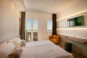 Posteľ alebo postele v izbe v ubytovaní Hotel Delfino